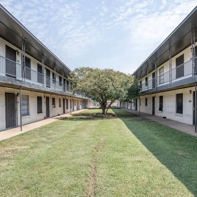 Apartment Complex Courtyard View of a two-story apartment complex with a grassy courtyard