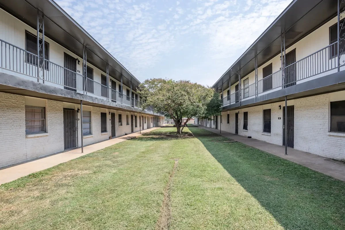 Apartment Complex Courtyard View of a two-story apartment complex with a grassy courtyard