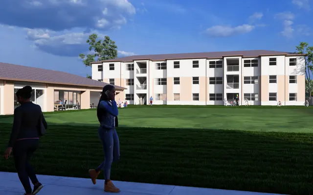 Newly Constructed Apartment Complex A modern apartment complex with three stories, set against a picturesque sky. Two people walk on a sidewalk in front of a green lawn, with trees in the background. The complex features multiple balconies and large windows.