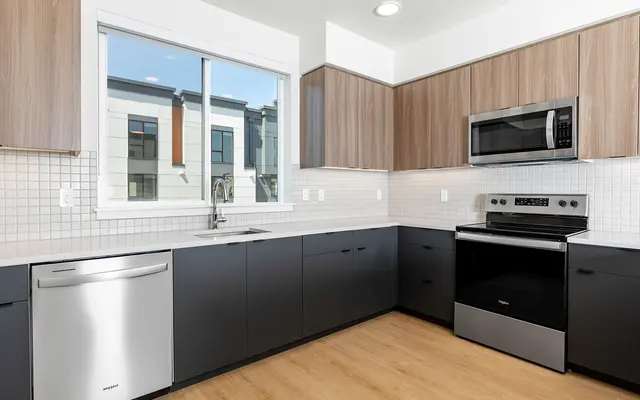 Modern Kitchen Design A modern kitchen featuring sleek cabinetry, stainless steel appliances, and a large window allowing natural light in.