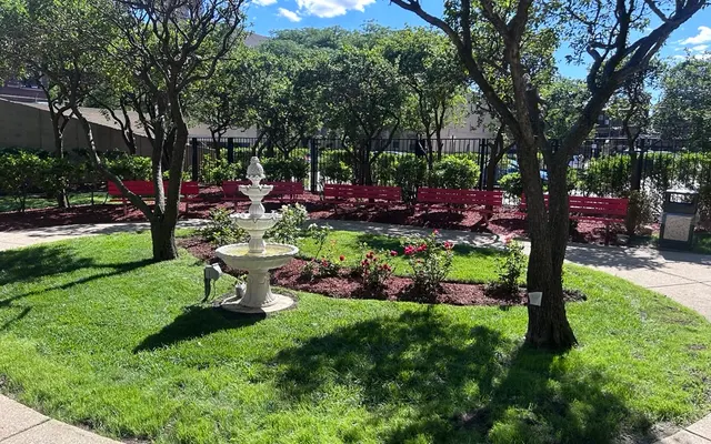 Community Garden Oasis A sunny community garden featuring a fountain, benches, and trees.