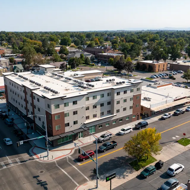 Downtown Building Aerial View Aerial view of a multi-story building in a downtown area, with surrounding streets and vehicles visible.