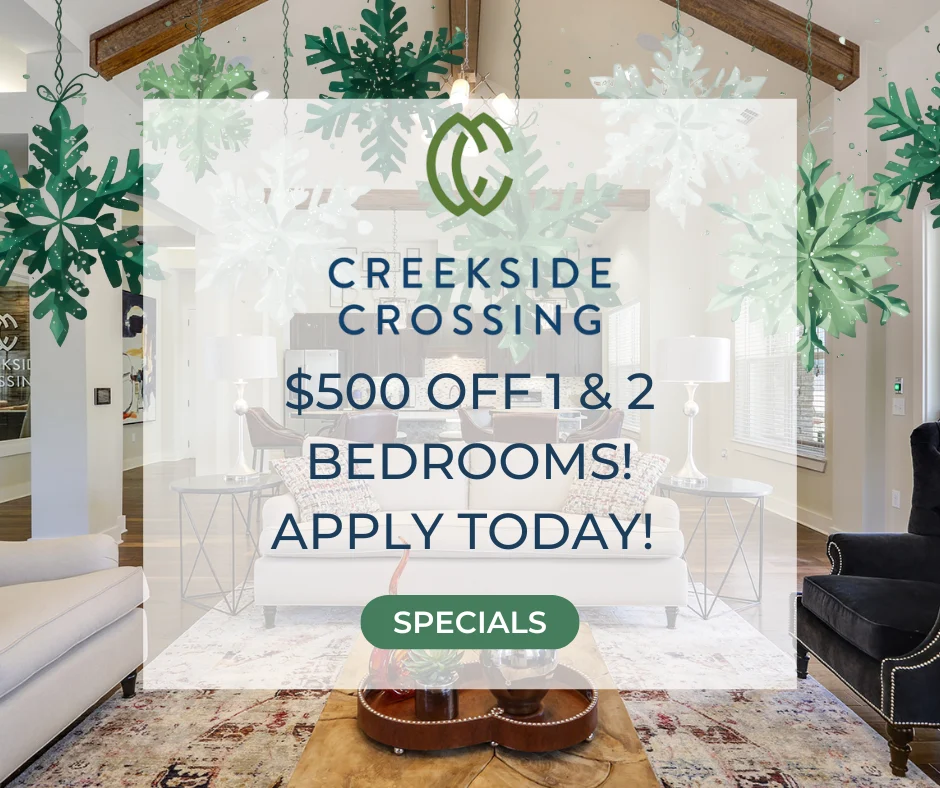 Promotional advertisement for Creekside Crossing offering discounts on one and two-bedroom apartments, featuring a spacious lobby area with decorative elements and furniture.