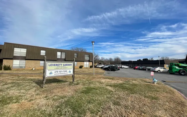 Leverett Garden Signage and Surroundings View of Leverett Garden sign in front of a building with a parking lot and blue sky.