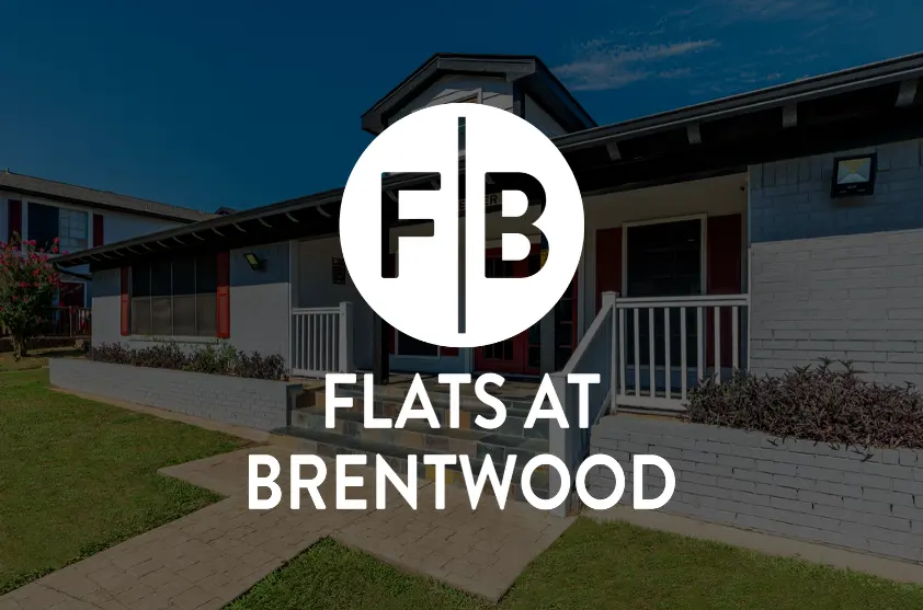 Flats at Brentwood Exterior view of the Flats at Brentwood with a sign featuring the initials FB in a circular design.