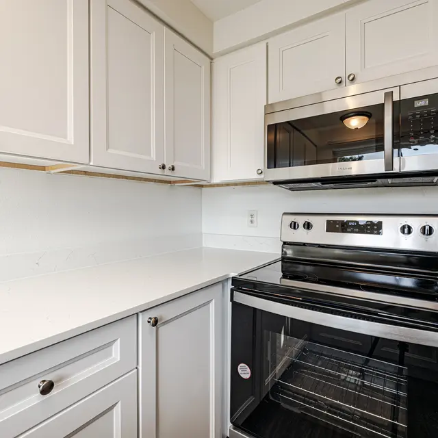 Modern Kitchen Interior A modern kitchen featuring white cabinetry, stainless steel appliances, and a clean countertop.