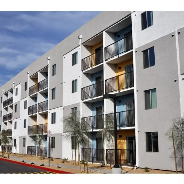 Modern Apartment Complex A modern apartment building with multiple balconies and a light gray exterior.