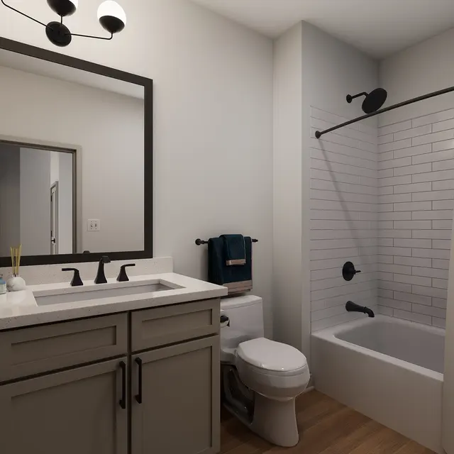 A modern bathroom featuring a dual sink vanity, a framed mirror, and a bathtub with a shower curtain. The flooring is wooden, and there are contemporary light fixtures on the ceiling.