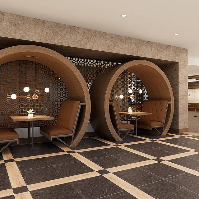 A modern café interior featuring two circular wooden booth seating areas with pendant lights, set against a textured backdrop and tiled flooring.