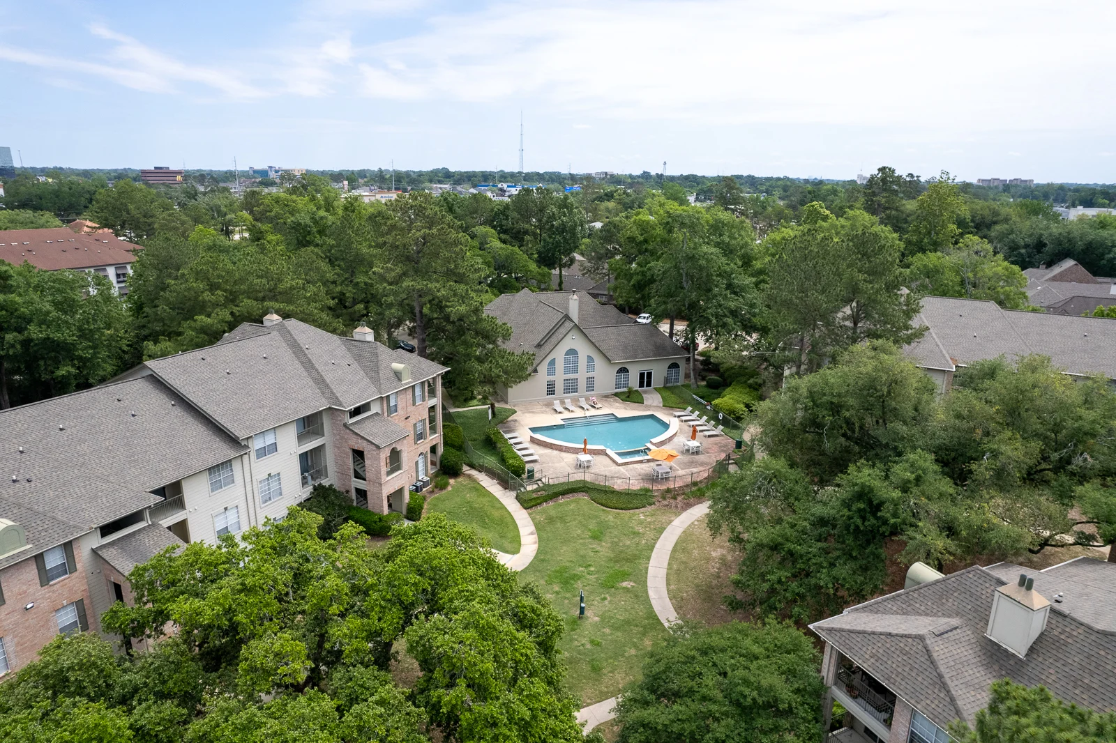 Community Pool Area in Apartment Complex Aerial view of a community pool and surrounding landscaping in an apartment complex.