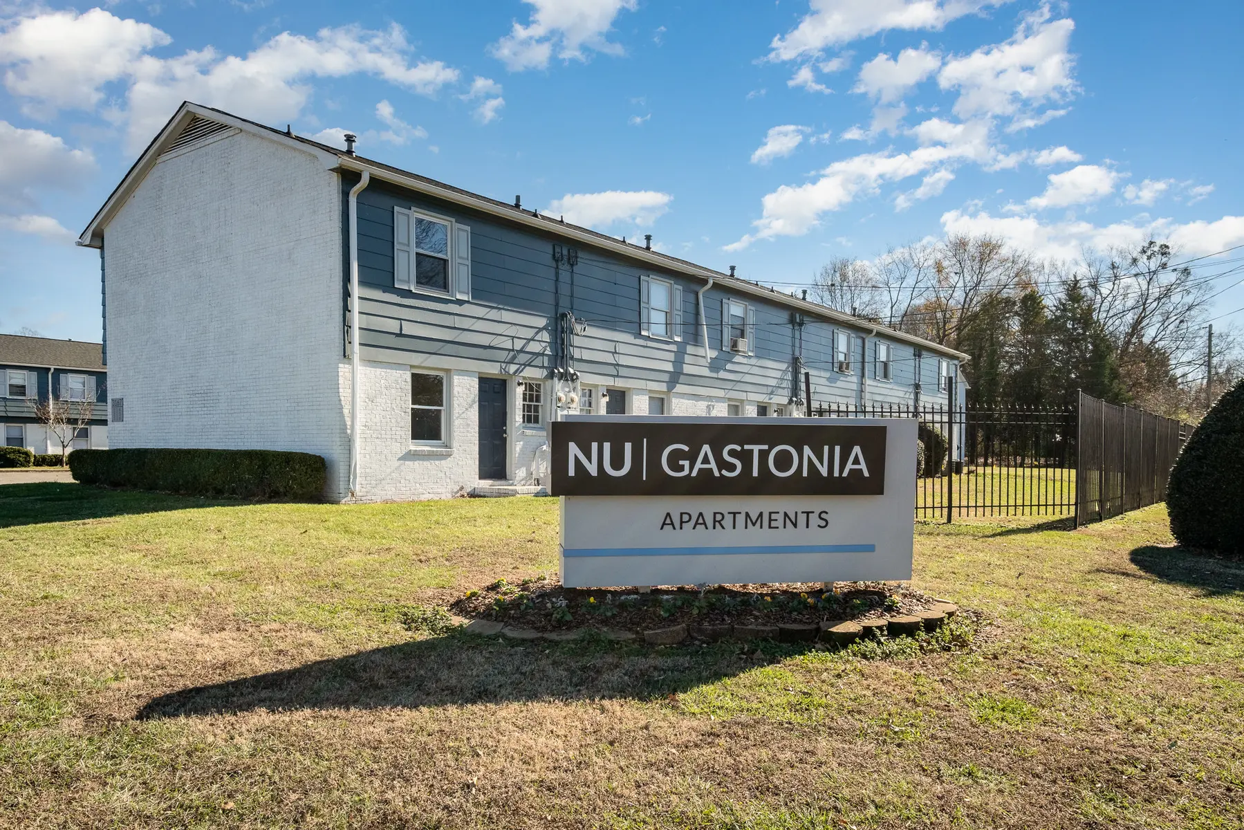 Exterior view of Nu Gastonia Apartments, showing the building facade and signage in front.