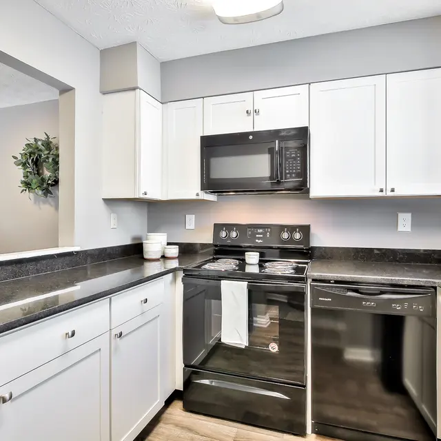 Modern Kitchen Design A modern kitchen with black appliances and white cabinets.