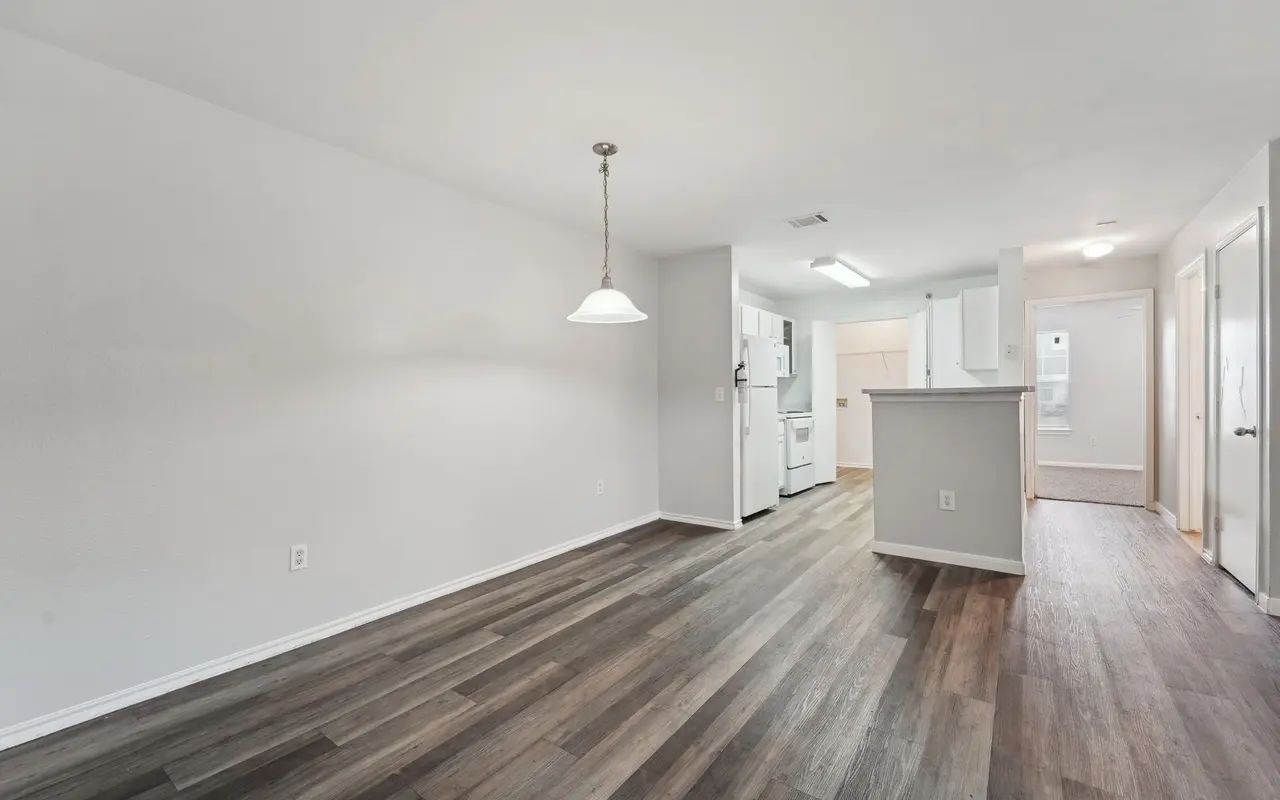 Interior view of a modern apartment with wooden flooring and a pendant light