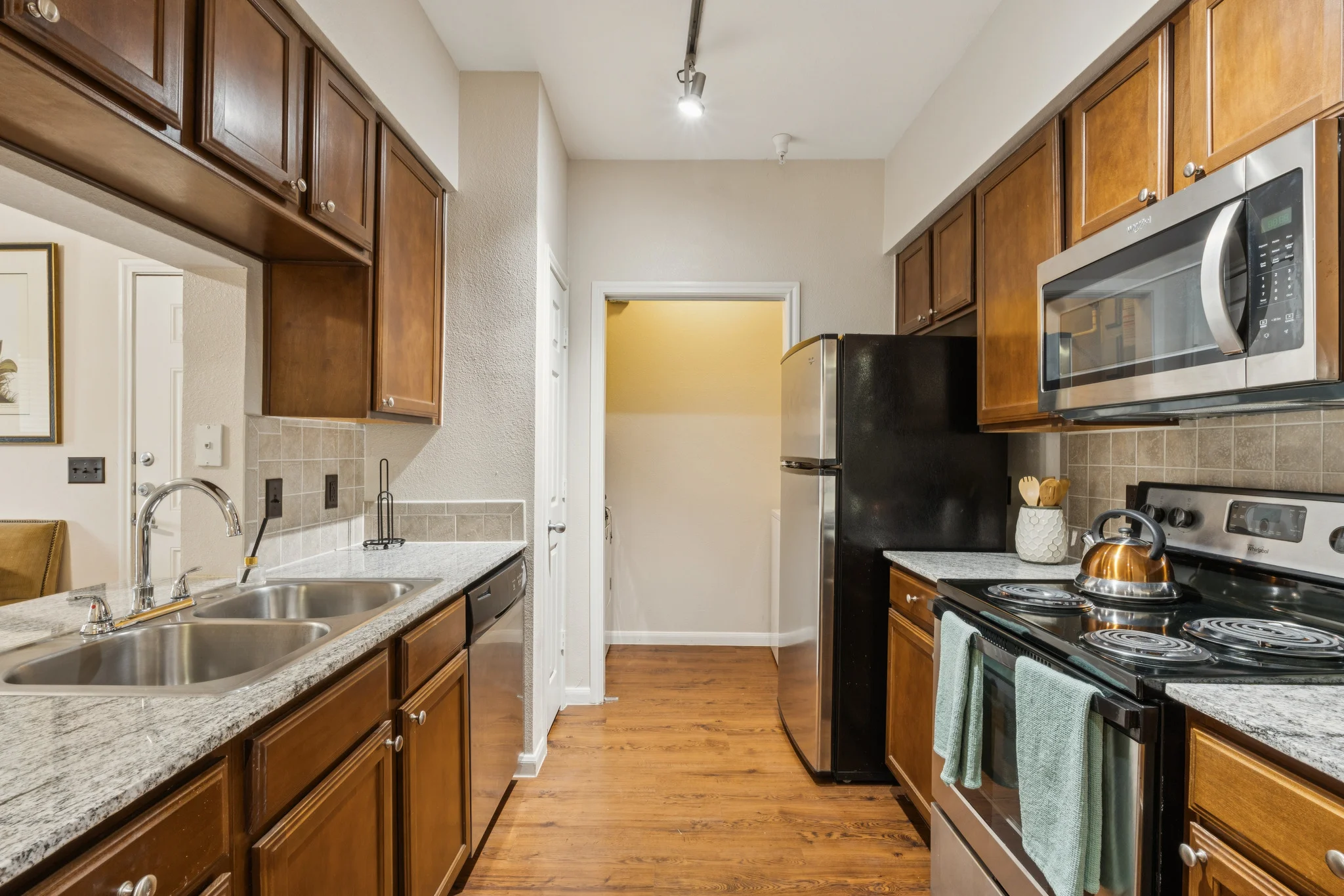 Modern Kitchen Design A modern kitchen featuring dark wood cabinetry, stainless steel appliances, and a granite countertop.