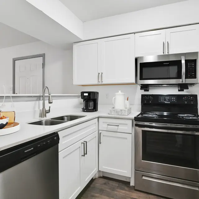 Bright and modern kitchen with stainless steel appliances and white cabinets