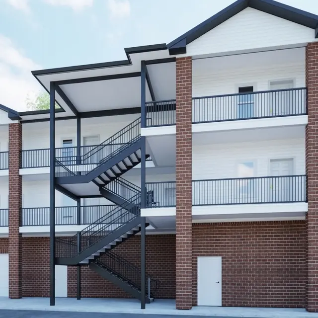 A modern apartment complex with a brick exterior and a spiral staircase in the center.