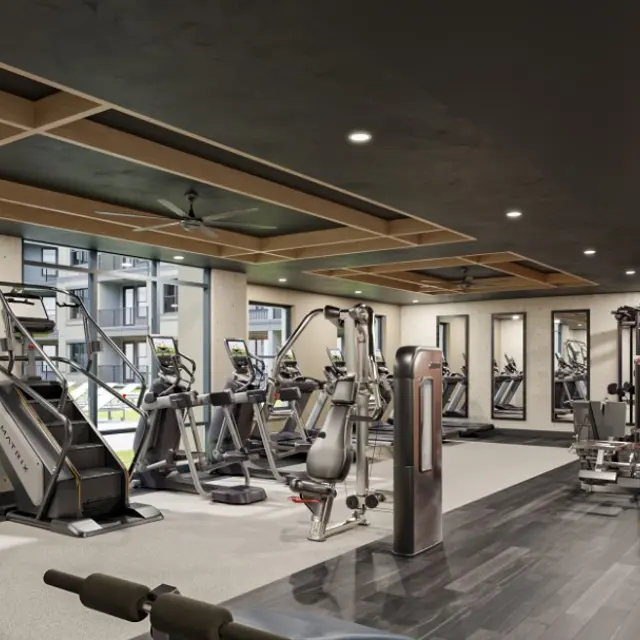 Contemporary Gym Interior A modern gym interior featuring exercise equipment, large windows, and a wall with the phrase 'RISE & GRIND.'