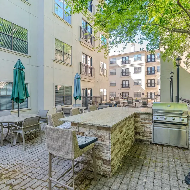 Outdoor patio area with grill and seating