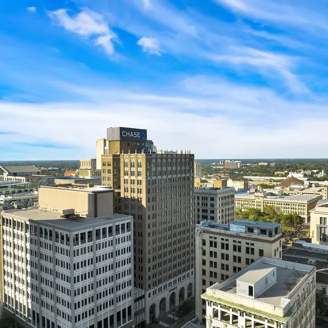 Downtown Skyline View Aerial view of downtown buildings with a clear blue sky and some clouds above.