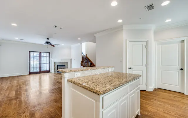 Spacious Modern Living Room Spacious modern living room with hardwood floors and a kitchen counter overlooking the area.