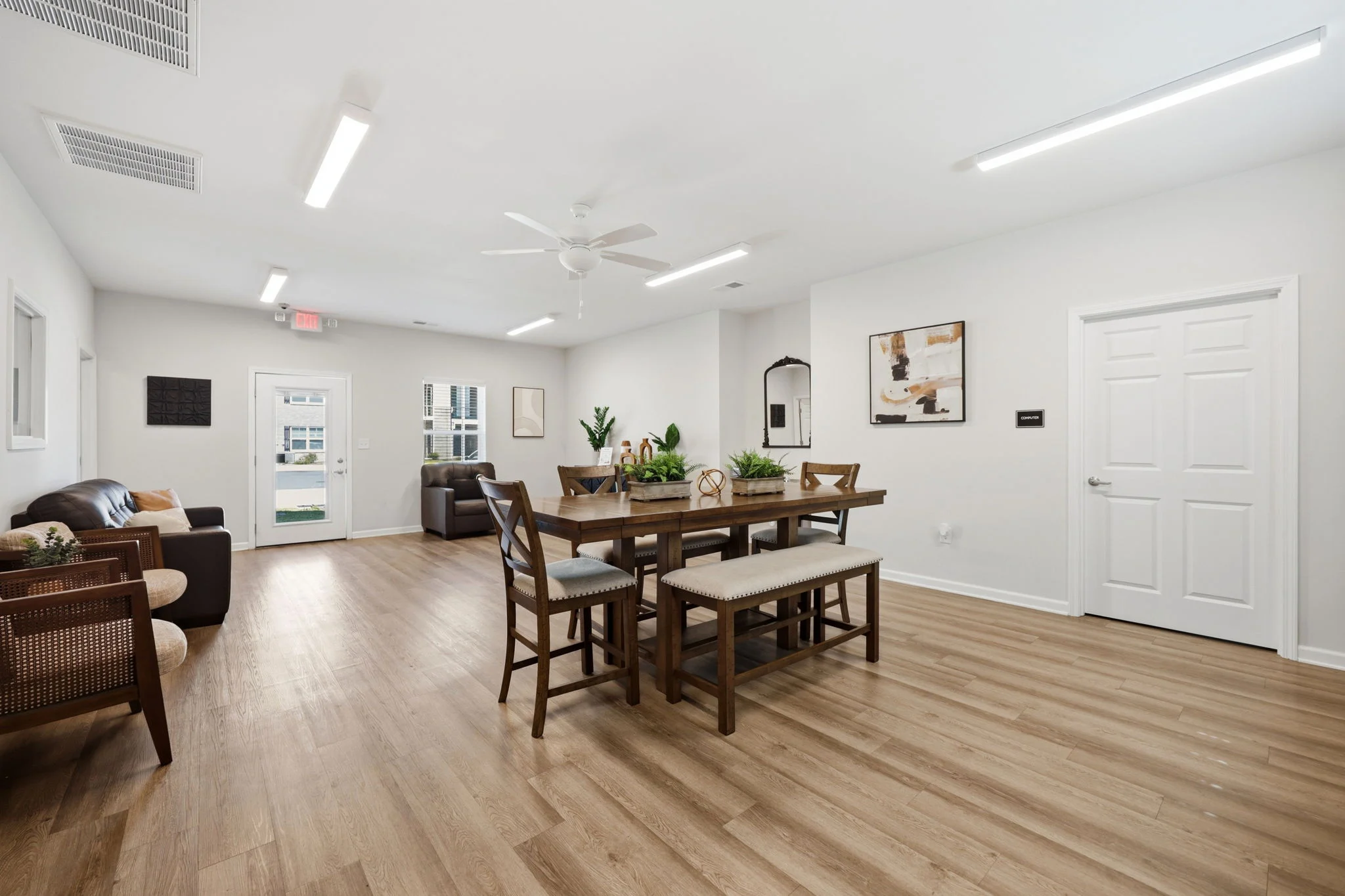 Modern Dining Area Spacious dining area with a large wooden table, benches, and seating areas, featuring a minimalist design and wooden flooring.
