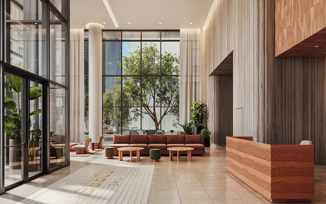 A spacious modern lobby featuring large glass windows, natural light, greenery, and stylish furniture.