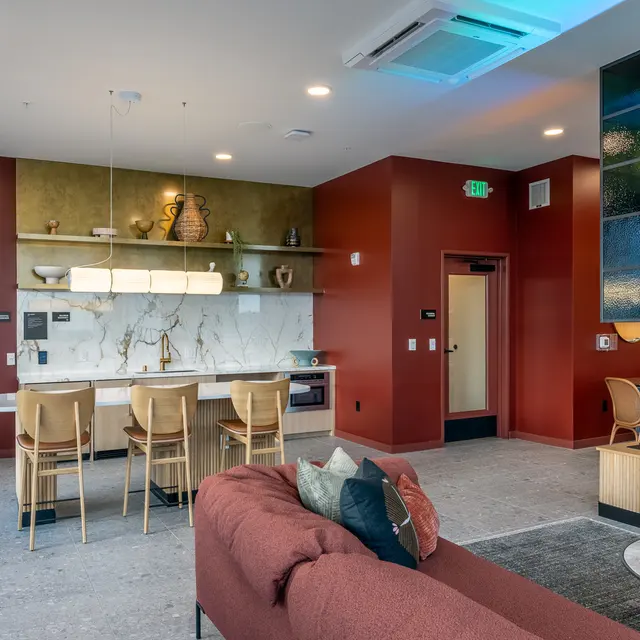 Interior of a modern apartment showcasing a kitchen and living area with stylish furniture and decor.