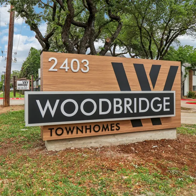 Sign for Woodbridge Townhomes displaying the address 2403.