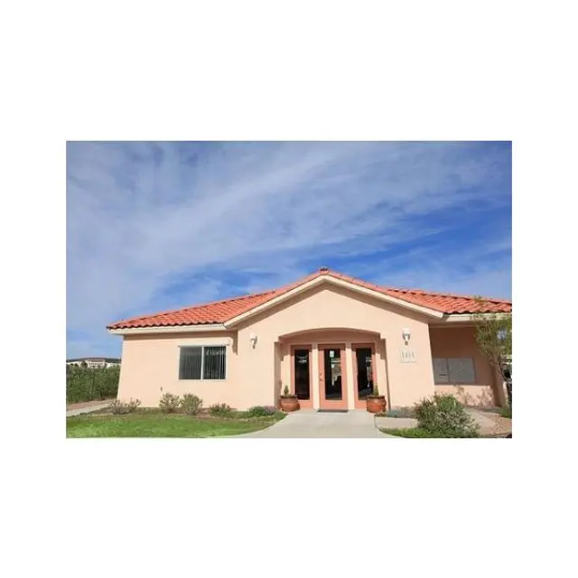 Charming Single-Story House A single-story house with a red-tiled roof, light beige walls, and a pathway leading to the front door. The house is surrounded by a small lawn with shrubs and potted plants.
