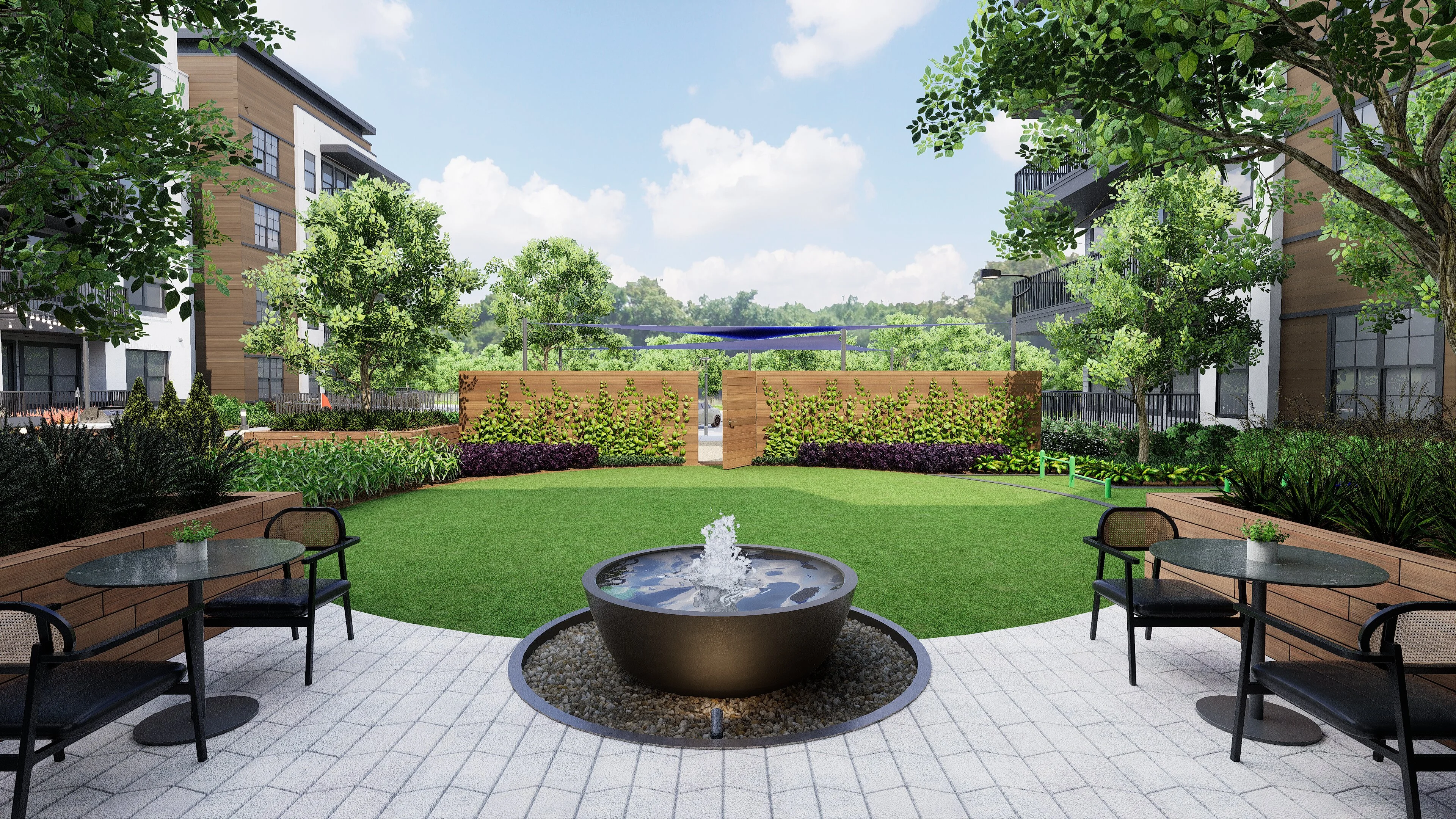 A modern apartment courtyard featuring a circular fountain, surrounded by seating areas and lush greenery.
