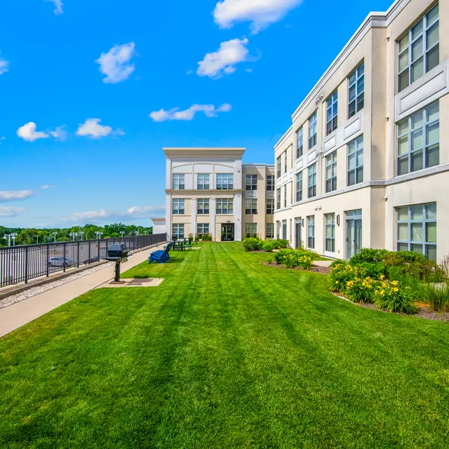 Modern apartment building with green lawn and blue sky