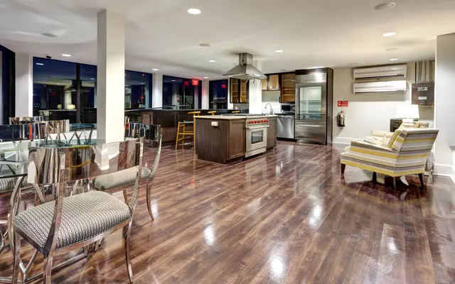 Modern Kitchen and Living Area A modern kitchen and living area featuring hardwood floors, contemporary furniture, and large windows providing natural light.