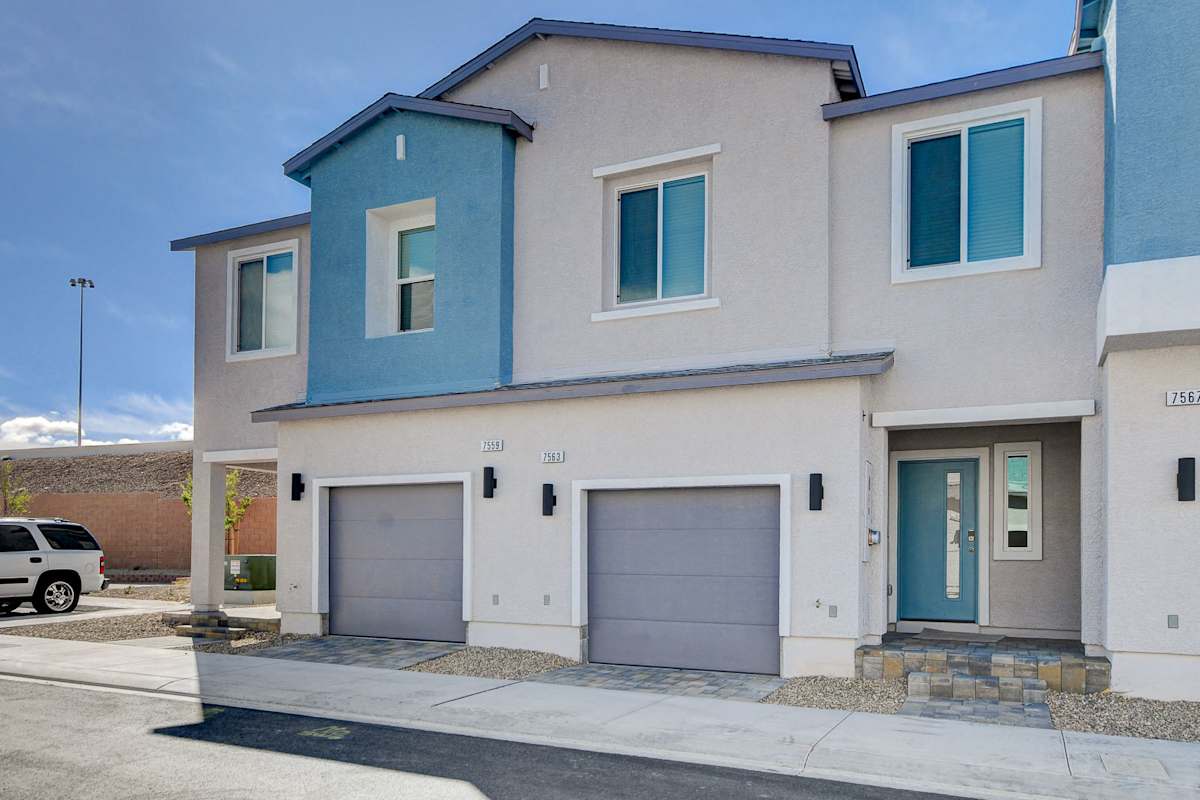 Stylish Modern Townhouse Modern townhouse exterior with two garages and a front entrance.