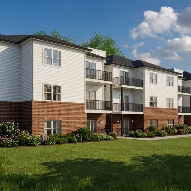 A modern apartment building featuring a mix of white and brick exterior with balconies and landscaped grounds.