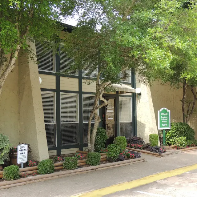 Office Building Exterior Exterior view of an office building surrounded by trees and shrubs.